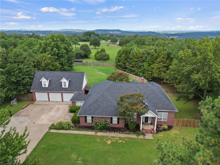 Stunning home in East Fayetteville boasts a prime location on 3 acres of flat land, complete with a cleared out wooded area, mature trees, & a serene setting. The upscale home features an amazing open floorplan, perfect for entertaining & everyday living. Formal dining room and large living room with vaulted ceiling, tons of natural light, wood burning fireplace, & wood flooring provide a cozy and inviting atmosphere. Chefs kitchen is a dream come true, complete with a large island, granite counters, stainless steel appliances, walk-in pantry, & gas cooktop. Luxury master bedroom with spa-like master bathroom is a true retreat. Large bonus room on the main level, & another bonus room upstairs above the garage with a balcony overlooking the 3 acres. Heated & cooled sunroom area leads to a large deck on the back of the home overlooking the beautiful 3 acre land. Lower garage is heated & cooled- not included in sq ft. New roof Aug. 2023.