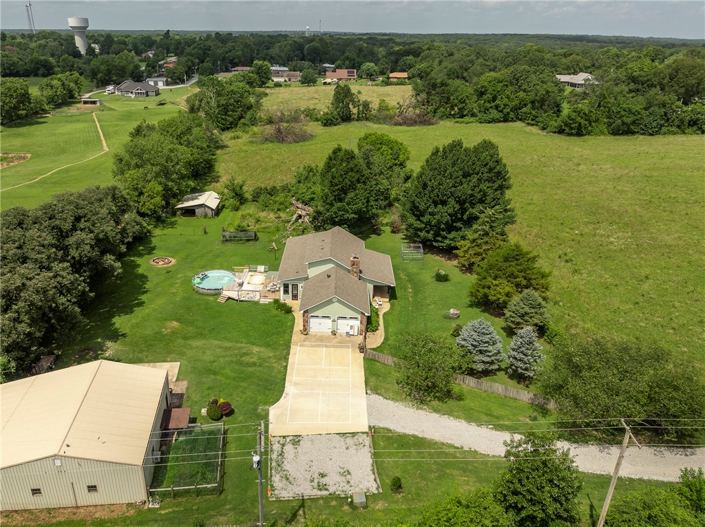 Tucked away on 8.4 acres, this rare in-town gem offers the best of both worlds: secluded rural living with unbeatable access to schools, parks, and amenities. Fully fenced and full of charm, the property features a massive 2,080 square foot shop with four bay doors, perfect for hobbies, storage, or business needs. The updated kitchen flows into a cozy living room, while the screened porch and hot tub offer year-round relaxation. The spacious primary suite is conveniently located on the main level, with two additional bedrooms and a full bath upstairs. Bonus features include a chicken coop, mature trees, and room to roam. Whether youāre looking for privacy, productivity, or a little backyard homesteading, this one checks all the boxes.