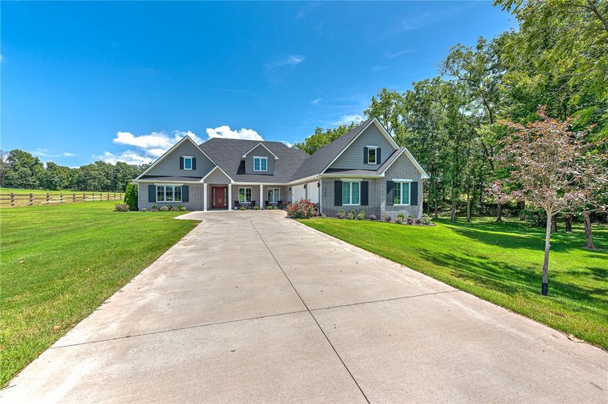Your private 3.5-acre retreat with an exceptional custom-built David Harris home awaits—offering serene country living just minutes from the vibrant amenities of Rogers and Bentonville and just 10 minutes from XNA! This meticulously designed and crafted masterpiece offers primarily main-level living for ultimate convenience. Step into a bright and airy open-concept living area that flows seamlessly to an incredible oasis with a private inground pool, expansive covered patios, outdoor kitchen, and peaceful country views. Designed for the culinary enthusiast, the gourmet kitchen showcases ample cabinetry, a large island, double ovens, a gas cooktop, and a walk-in pantry! Private master suite features a sleek en suite bath and amazing w/in closet! Dedicated office/nursery, open formal dining space, elegant living room w/ fireplace & built-ins, upstairs media/bonus room w/ powder bath, 3 car garage w/ attached workshop, storm shelter, 3 stage water filtration system, 9.5 KW solar system, fully irrigated lawn!