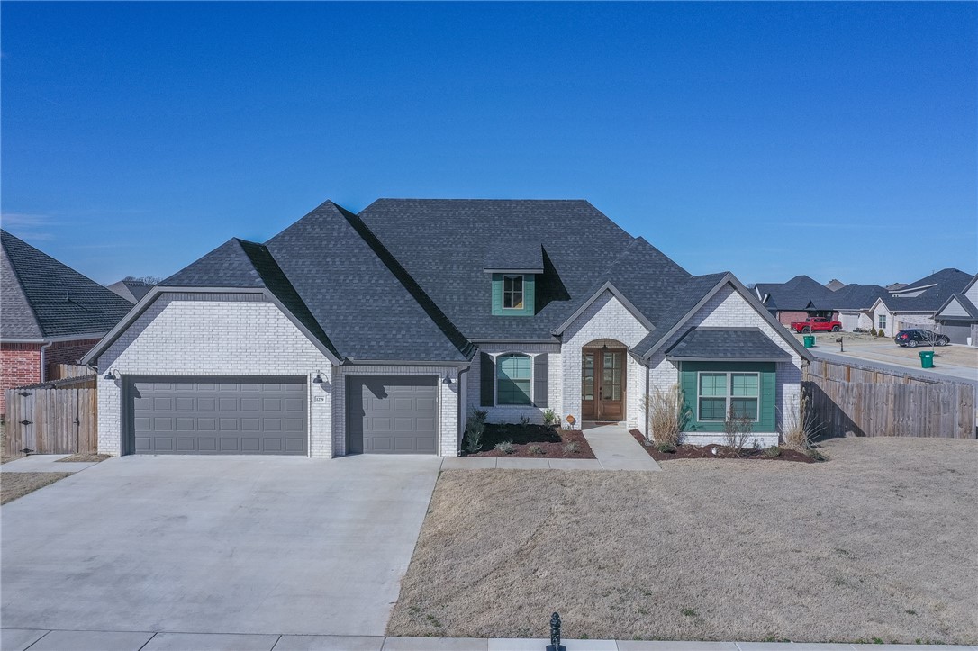 Welcome to your new home in Tontitown, Arkansas! This spacious 4-bedroom, 3-bathroom residence boasts 2,468 square feet of modern living space. The open concept layout seamlessly connects the living, dining, and kitchen areas, perfect for entertaining or family gatherings.
The kitchen is a chef's dream with granite countertops, a gas range, and a huge walk-in pantry for all your storage needs. Enjoy the convenience of an office and a split floor plan offering privacy for the primary suite.
Step outside to the covered patio with an added extension and fire pit, ideal for outdoor relaxation. The fenced backyard on a corner lot provides privacy and space for outdoor activities.
With a three-car garage and a new storage building, this home offers ample storage for vehicles and outdoor equipment. Modern finishings and amenities complete the package, making this home the perfect blend of comfort and style in Tontitown, AR. VETERANS Please inquire about a 4.2% INTEREST RATE on this home.