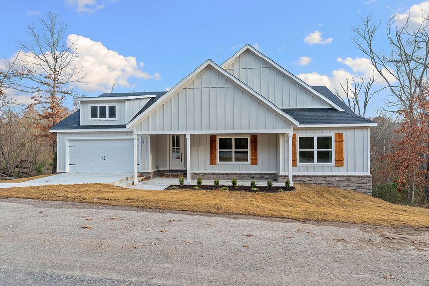 Beautifully crafted new construction home blending thoughtful design with a serene, retreat-like setting. This home features 7" hand-scraped engineered wood flooring throughout—including closets—paired with stylish tile in the bathrooms & laundry for a cohesive, elevated feel. The inviting living space is anchored by a cozy electric fireplace, creating a warm, peaceful atmosphere perfect for relaxing evenings. The spacious kitchen offers 3 cm Black Pearl granite countertops, stainless steel appliances, sleek black finishes, & a large pantry. Step outside to a generous, private back deck overlooking mature trees, offering a gorgeous wooded backdrop and a true sense of tranquility—perfect for morning coffee or unwinding at the end of the day. Enjoy access to Bella Vista’s premier amenities, including mountain biking trails, hiking trails, golf courses, lakes, pools, fitness centers, tennis, pickleball, archery, and saunas. A lifestyle of comfort, outdoor entertainment, and a beautiful  peaceful retreat to call home.