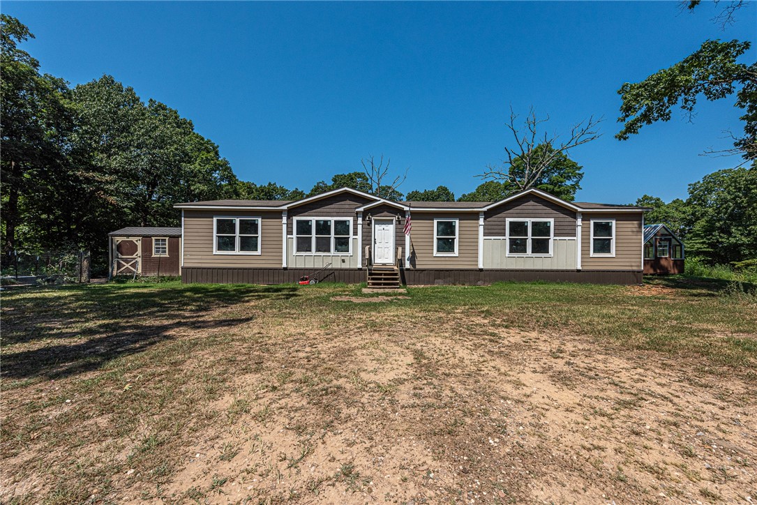 Tucked away in the woods, this 4-bedroom, 2-bath manufactured home on a permanent foundation sits on 9.67± acres is the opportunity you’ve been waiting for! Just 10 miles from West Fork and I-49, and under 20 miles to Lake Fort Smith and other state parks, this property offers both convenience and seclusion. The home features an open-concept living and kitchen area, a spacious primary suite with walk-in closet and ensuite bath, plus three additional bedrooms and a dedicated laundry room, ready for your personal touch and renovation. Outside, enjoy two 8x12 storage buildings, a Dersken brand 8x12 greenhouse, a stocked pond (Blue Gill / Crappie / Catfish), Dersken brand chicken coop, gardening area, and endless wooded acreage perfect for exploring, hunting, or simply soaking in Arkansas nature. BONUS: New Bathroom Vanity, new butcher block counters and Refrigerator included! Don’t miss your chance, schedule your showing today! **Property Sold As-Is**