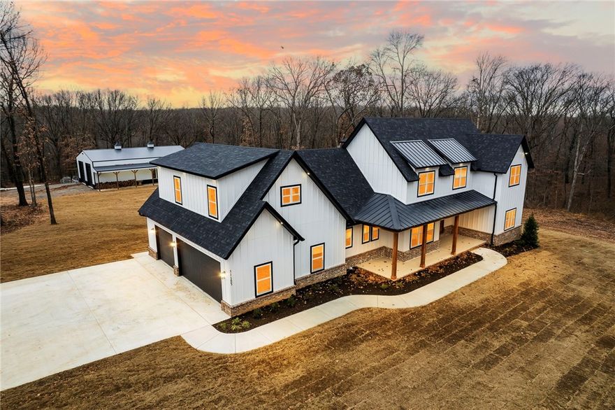 This stunning upscale home boasts meticulous attention to detail & luxurious features. The 60x40 insulated shop is ideal for hobbies or business. The chef's kitchen is a culinary dream. The walk-in pantry is a masterpiece with large prep area & sink. Throughout the home, custom built-ins and marble countertops seamlessly integrate. The office is a productive workspace, while the living room impresses with two-story windows. A two-tier wrought iron chandelier adds ambiance, & the loft overlooks downstairs, creating connectivity. The primary suite is a retreat with an oversized walk-in closet & direct access to a screened-in porch provides a serene escape. An above-garage living space with a kitchenette adds versatility. The outdoor area is a haven for relaxation, featuring a covered patio with 6000-watt heaters, an outdoor shower, & direct access to a half bath. Situated on approximately +/-5 acres, the property offers space for outdoor activities. It's not just a home; it's a lifestyle of luxury & comfort.