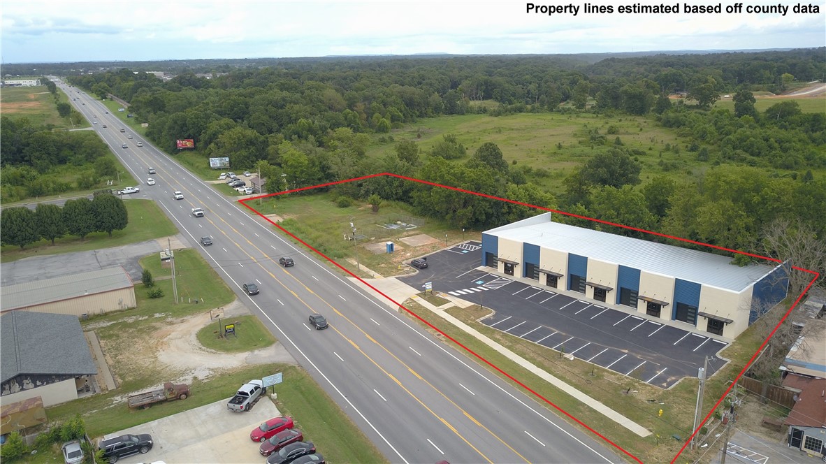 New construction commercial building located on high-traffic Hwy 71B/Bloomington with approx. 20,000+ vehicles per day. Property sits on approx. 1.44 acres and includes additionally empty lot next to building, offering flexibility for expansion, parking, or future development. The building features 5 sections, each measuring 30' x 120', with 12' roll-up doors on each section; Section A includes two 12' roll-up doors. Excellent visibility and access just minutes from JB Hunt HQ, I-49, and downtown Rogers.