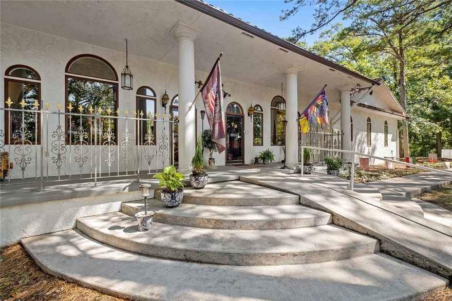 Tuscan Manor's stucco exterior, arched windows, wrought iron accents and the iconic look of a terracotta roof evokes the cozy feel of a Tuscan villa. It's the perfect getaway with four spacious guest suites and a 2BR/1BA owner's apartment. The commercial zoning allows for numerous uses within minutes of historic downtown Eureka Springs, one of Arkansas' most popular travel destinations. Guests enjoy gathering in the great room with wood beamed ceilings, two native stone fireplaces and a casual bar. There are two large kitchens with custom cabinetry and a private dining area. An inviting sun room in the back is the perfect space to relax. An elevator provides access to the lower level apartment as well as an office and massage area. There's a fire pit, patio and a covered front porch for relaxing outdoors. Weddings are also a growing source of income and could easily be increased. The property has two full RV hookup sites. Quick bike ride to the Passion Play trails. On the trolley route.