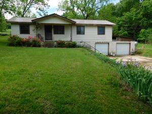 Nice 1 Acre Homesite on Paved Highway, lots of shade trees, garden spot, fenced yard, and 2 storage buildings. Home has new metal roof and new windows installed in recent years. Basement area is 2 garages or work shop area, house is connected to Pyatt city water, there is a well in back yard not used for several years. Pretty setting with lost of flowers and several large walnut trees in yard, storage bldgs are 10x12 and 8x12. Hardwood flooring is visible in some areas and also believed to be hardwood under most of the carpet. Age, sq ftg, lot size, acreage, utilities, etc, are from public records, Buyer should verify. Age, sq ftg, lot size, acreage, utilities, etc, are from public records, Buyer should verify.