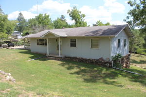 Here is a nice 1500 sq ft, 3 bedroom, 1 1/2 bath house on 4.5 acres of land. The house has a full unfinished basement with a large cellar at one end. There is a large covered deck on two sides of the home where you can sit and watch your animals graze in the pasture below. A two car carport & a large outbuilding is also on the property. Home is only 1/10 mile off of state paved hwy. Country living at its best right here!
