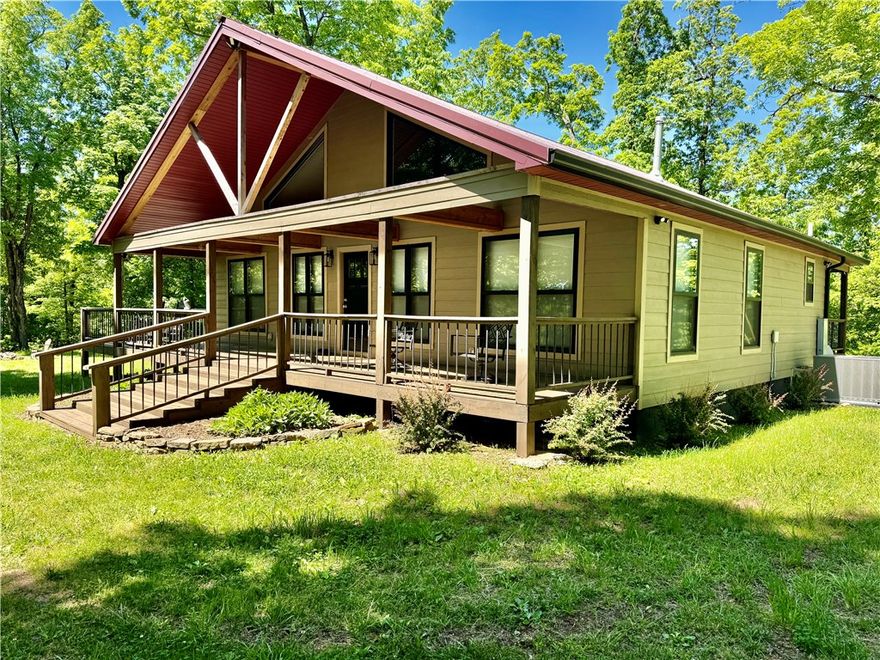 Custom-built furnished cabin near Pettigrew, AR, with gated access and direct access to the Ozark-St. Francis National Forest. Features include an open floor plan, vaulted ceilings, a wraparound porch, high-speed internet, a rainwater collection system, a storage container with a lean-to, a trail system, and recreational opportunities for hunting, ATV riding, and outdoor use.