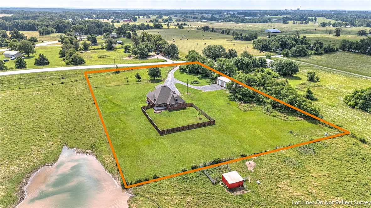 Come see this estate escape in Bentonville! This home has 6 bedrooms, and 4.5 bathrooms with over 3600 square feet to enjoy! Three options for primary bedroom suites/ensuites, with the newest remodel being upstairs. Some additional things to note are the large closets, generator hookup capability, Maintained septic, public water, all electric, kitchen remodel and upstairs remodel 2019, wood burning fire place, huge attic walk in storage, new survey and so much more to see! To make this home even more appealing there are 3 flat acres included, along with a large 30X50 shop, and RV parking space and hookups. Looking for peaceful living, but close to I-49 and everything local just minutes away?! This is it! Check out the potential of making this large home yours, enjoying the sunset dinner views, and tinkering around your very own private shop.