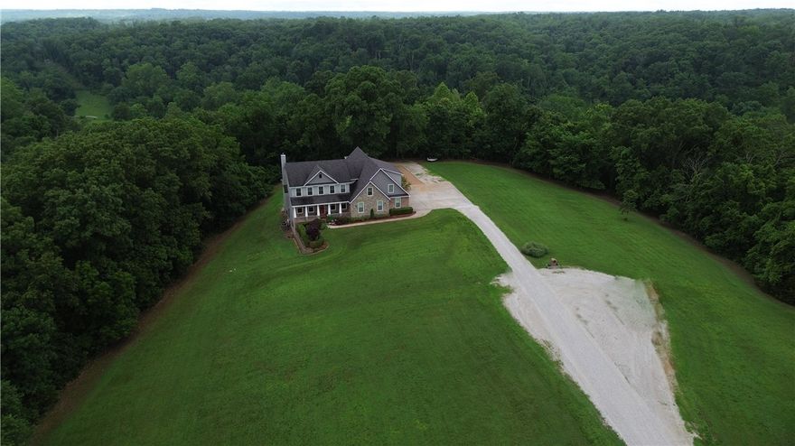 Welcome to 11010 Meadow Lark Rd in Rogers, Arkansas. First time ever on the market, this custom-built dream home is nestled at the end of a quiet cul-de-sac on 9.53 acres, backing up to mature trees for a peaceful, wooded backdrop. Ideally located just 10 minutes from downtown Rogers and less than 20 minutes from the new Walmart Home Office, this property offers both convenience and privacy. With three spacious levels and a total of 5,130 heated square feet, there’s plenty of room to spread out while still enjoying a warm and inviting atmosphere. Thoughtfully designed with quality craftsmanship throughout, the home features a safe room, a partial backup generator, and energy-efficient solar panels that keep utility bills remarkably low. Perfectly suited for everyday living and entertaining, this one-of-a-kind retreat offers timeless finishes, modern comforts, and a tranquil setting you’ll fall in love with the moment you step inside. Don’t miss your chance to own this sanctuary in the heart of Northwest Arkansas.
