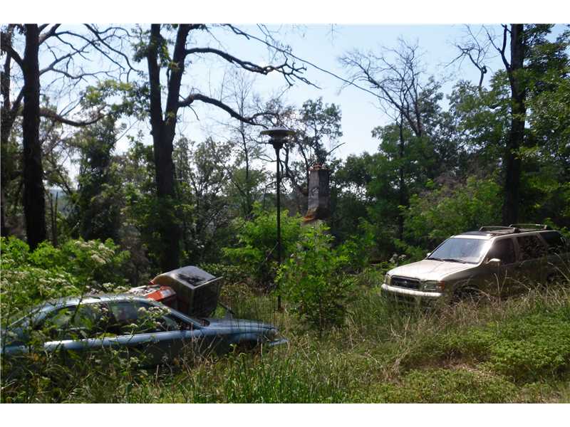First time offering. Two story house burned July 2011. Property includes older mobile home in not good condition--may be salvagable. Beautiful forest lane with old roadbed in place behind next door neighbor's mobile home. Poss financing with 40% down.