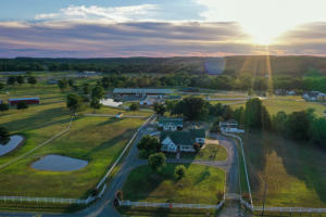 Exceptional Horse Ranch property with 2 homes and over 33000 sf riding arena.ThisTurn-key ranch has all the amenities already in place for its new owner. Starting with a beautiful 3b/2b 2349sf Ranch home that features an in ground pool, fireplace, 2 car garage, pool house, outdoor bar area and much more all overlooking your picturesque country setting. A separate 3b/2b 2384sf Beautiful Log home that features a fireplace, screened in porch, office, cathedral ceilings, 1 storage building, an attached workshop and sets along side Scroggins creek that is just full of bass for some additional beauty and outdoor recreation. You will be amazed at the over 33,000sf riding arena that is already set up for roping and barrels.