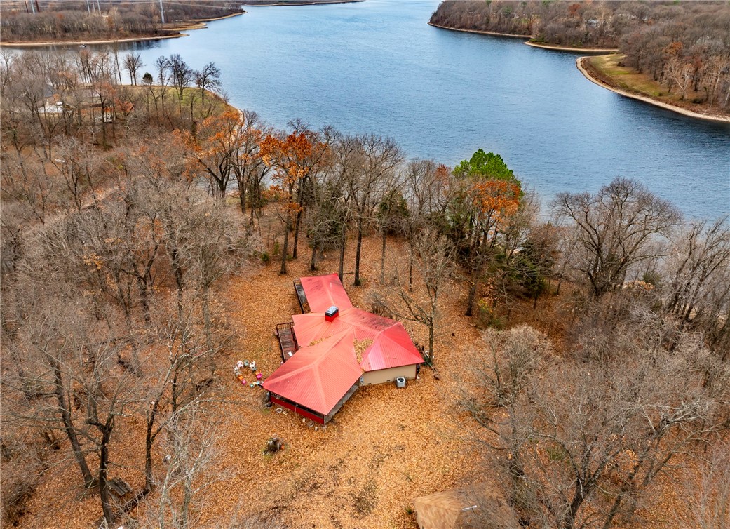 Charming Lakefront Gentleman's Farm on 10+ Acres! Welcome to this picturesque 1,654 square-foot home nestled on over 10 acres of stunning lakefront property. Enjoy incredible views and a serene lifestyle with ample space for gardening and outdoor activities. This gentleman's farm is a nature lover's paradise, featuring great fishing opportunities and abundant wildlife, including deer, eagles, and turkeys. The home boasts a cozy wood-burning fireplace, perfect for those chilly evenings. The basement includes a storm shelter for added peace of mind. With potential for a boat launch area, you can easily access the water for all your recreational needs. Don’t miss this unique opportunity to own a slice of paradise where tranquility meets adventure. Schedule your private showing today!