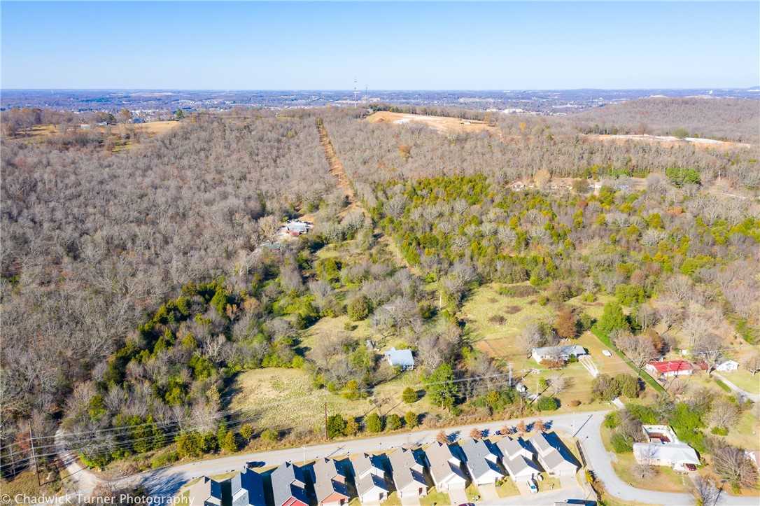 Location Location Location! 20 acres +/- that adjoins the planned Centennial Bike Park on the north side, near the U of A, Kessler Mountain Sports Park and quick access to I-49. Hillside topography lends itself to a multitude of possibilities. Build your own private retreat in the heart of everything or consider multiple development opportunities.