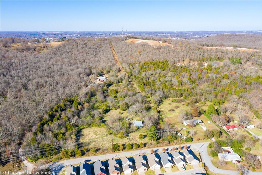 Location Location Location! 20 acres +/- that adjoins the planned Centennial Bike Park on the north side, near the U of A, Kessler Mountain Sports Park and quick access to I-49. Hillside topography lends itself to a multitude of possibilities. Build your own private retreat in the heart of everything or consider multiple development opportunities.