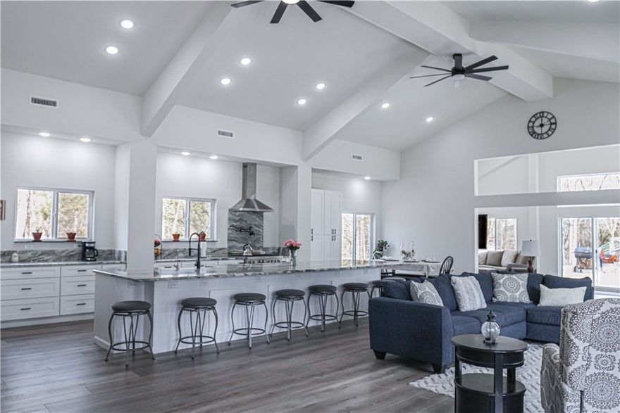 Experience the pinnacle of off-grid living with this luxurious, solar-powered steel home on 78 acres near Tucker Hollow boat dock. Completed in 2023, this stunning retreat features 57 solar panels, 54kWh of battery storage, a Kohler LP generator with auto-start, and a deep solar-powered well producing 50 GPM—designed for seamless self-sufficiency. Inside, enjoy a spa-style bath with a 7’ walk-in shower and soaking tub, chef’s kitchen with a 15’ granite island, 6-burner Z Line gas range with pot filler, and a massive 9x15 walk-in closet. The cozy wood-burning stove, dual gas furnaces, and high-efficiency HVAC system keep the home comfortable year-round. ATV trails lead to a creek, while a chicken coop, gas wood splitter, and water filtration system round out this rare offering. Sold fully furnished and built to impress with sustainable design and modern luxury—this is off-grid living, elevated.