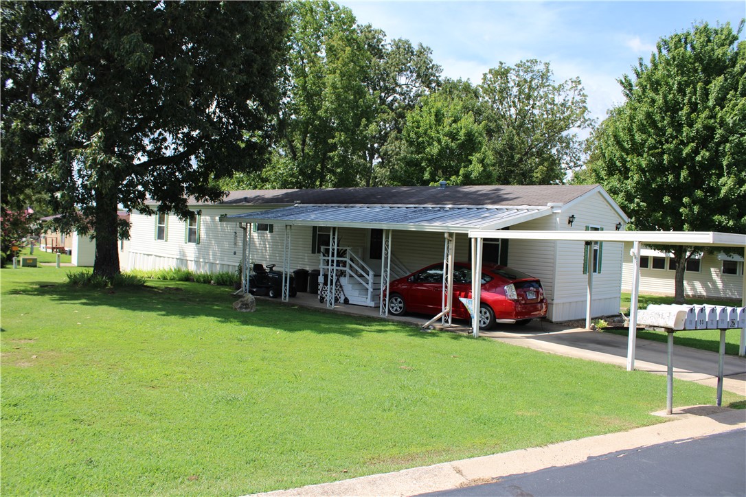 Rolling Meadows beauty! This two-bedroom mobile home is sitting in the sought after mobile home park that is conveniently located close to shopping, medical, restaurants and employment! Home features a covered front porch, carport, fenced area off of the back porch and a storage building! This home is clean, neat and ready for you to make it your own! Inside you will find a beautiful gas fireplace, split bedroom plan and an open kitchen/living room. Call today to schedule a look.
