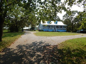 3BR, 2BA ranch style home approx. 2,064 sq.ft. 2 levels, located on 2.42 acres m/l. Park your boat in the 28x36 large 2 car attached garage/workshop, 14x28 enclosed porch, could be space for 3rd car also. Large covered porch spans the entire front of the house. New exterior paint Aug. 2021, new metal roof 2015, 2 new HVAC units 2021, wood stove in living room, setting area upstairs between bedrooms, office on main level, paved circle drive, pond. Home to sell AS-IS, needs interior remodel some water damaged floor, cash or in house loan only.