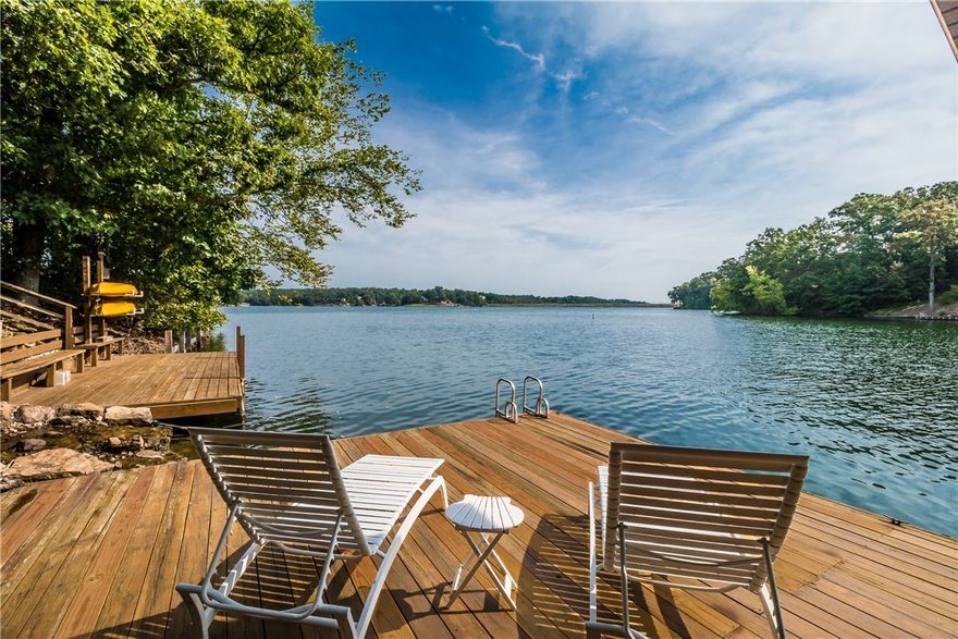 Luxurious one of a kind private lake front home on a 2+ ac peninsula w/Lake Loch Lomond on 3 sides of the property, featuring 970' of shoreline. This 4 bedroom, 3.5 bath home has been beautifully remodeled & features 2 master bedrooms, kitchen, dining areas, & living areas on both floors. Enjoy the outdoors sitting on 1 of the 2 decks, listening to the waterfall & watching the sunrise or set, working in the 1,000 SF shop or enjoying the lake with your very own single slip boat dock.