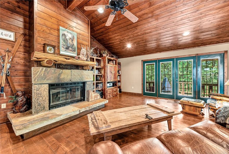 RUSTIC RETREAT FEATURING MAIN HOME, GUEST HOUSE, POOL, WORKSHOP ON 2.78 PEACEFUL ACRES. Near Beaver Lake’s Rocky Branch, every detail of this lodge style home has been thoughtfully crafted. The main home showcases custom doors, built-ins, real antler chandeliers, and wood-burning fireplaces. Downstairs offers a cozy pub, full bath, and workshop—ideal for entertaining or hobbies. A spacious 4-car garage with an extra roll-up door provides ample storage, and a whole-home Generac generator ensures year-round peace of mind. The guest house/in-law suite includes pine floors, a full kitchen, and private patio for extended stays. The attached heated/cooled shop has a half bath and potential for additional living space. Outdoor amenities include a solar-heated sport pool, hot tub, plumbed outhouse, turfed bocce ball court, RV parking, and lush landscaping filled with perennials and native plants. This one-of-a-kind property blends comfort, craftsmanship, and outdoor luxury.