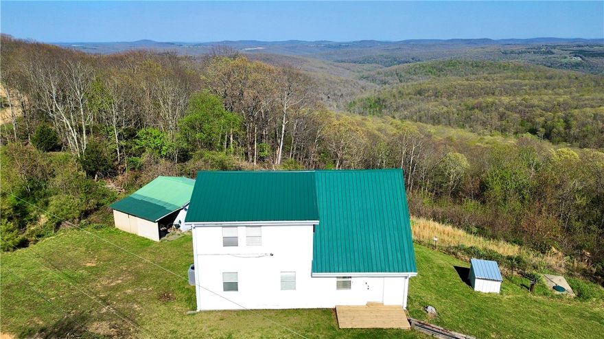 VIEWS, VIEWS, VIEWS!! Vacation calling your name? This has it all with a captivating drive to start with, gorgeous views of the Ozarks, War Eagle flowing on each side of the hwy to crossing a bridge over Seals Creek leading you to relax on your expansive deck with long beautiful views. You will not want to leave. Sold 'As-Is'. Existing well has collapsed. Fully self-sufficient, this home uses a stored water system that easily supports two occupants for over a week. Buyer to take responsibility for drilling a new well or restoring the existing water source. 3bed/2bath, all electric, 2 yr old metal roof, New Fridge. New energy eff washer/dryer. Note that the oven is currently out of order though the stove top works. 18x20 outbuilding. 20x20 storage building. The adjoining 23 acres is for sale see MLS# 1342544. Offers great hunting, hiking, camping, riding, & exploring with multiple wet weather creeks/streams traversing the property! Invest in both, escape to the Ozarks!