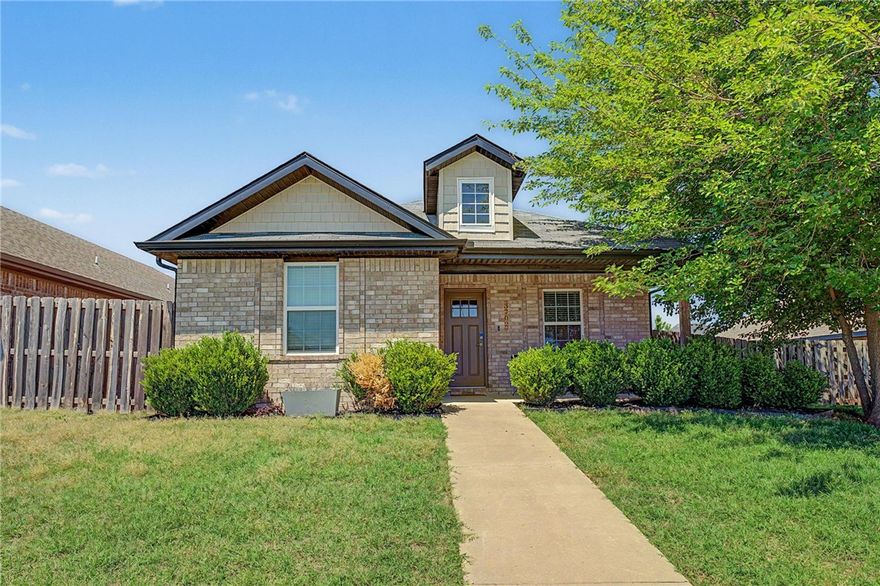 Welcome to a well-maintained all-brick home, ideally offering convenient access to the new 8th Street Gateway Park, 3.5 miles from the Walmart Home Office, and is in close proximity to trails and schools. Positioned on the largest lot in the neighborhood and the newest home on the street, this property combines space and functionality. Inside, the home features a seamless open layout with vaulted ceilings in the living room, tile flooring throughout the main living spaces, and a split floor plan. The spacious fenced backyard provides exceptional outdoor space, while the extended concrete patio creates the perfect setting for entertaining and gathering. Additional highlights include an updated dormer window for enhanced curb appeal and a rear-entry two-car alley garage. Currently operating as a successful short-term rental, this home is ideal for first-time buyers, investors, or those seeking a move-in ready property in a highly convenient Bentonville location. Furnishings may convey with an acceptable offer.