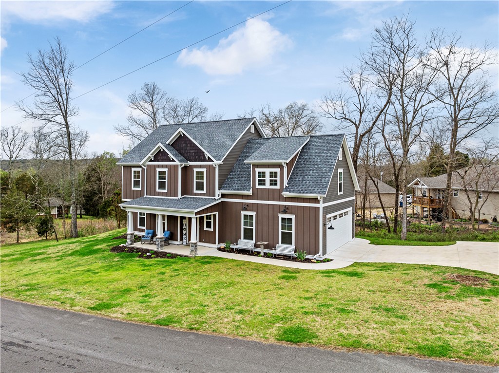 Gorgeous home in Bella Vista with a farmhouse design that sits on a large sewered and flat corner lot with side entry garage and long paved driveway with oversized covered back deck. Quartz countertops, large island, soft close cabinets and drawers, large pantry/laundry room combo with sink, formal dining, SS appliances and much more. Master upstairs features a walk-in closet and two smaller closets, double vanities, soaking tub and fully tiled shower. Three additional bedrooms upstairs with one that could serve as a bonus room. Open house Saturday and Sunday 2-4. Priced to sell!