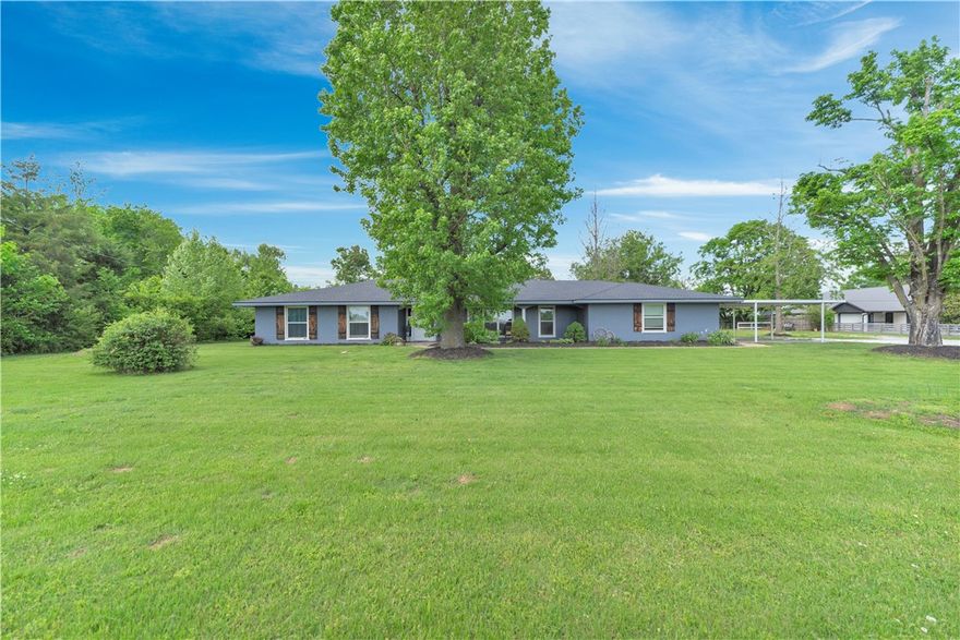 Looking for a house with flat land in the middle of town with no deed restrictions? Look no more, located next to Mountie Bike Trail and close to Rogers High School. Ranch style home with tons of updates, beautiful front covered porch , new luxury vinyl flooring throughout, spacious kitchen with granite counter tops and modern backsplash, range hood vent, formal dining area with fireplace, spacious living area with tons of windows for natural light, updated main bathroom with soaking tub, spacious 4th bedroom/bonus room, new roof and newer HVAC, large shop, large covered back patio with extended pergola to entertain your guests.