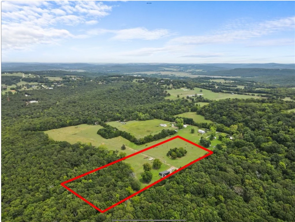 Barndominium on 10 +/- Acres in Elkins!! Step in to country living, just minutes from the White River. This recently built Barndo sits on 10 +/- acres, about 8 acres of pasture and 6 wooded acres. Additional acreage available. The home features 1 bedroom, 1 bathroom, steel beam construction, solid wood cabinets, and spray foam insulation. With 988 additional square feet, the shop provides ample storage or workspace, and is heated with a wood stove that conveys. Two bay doors, 10ā and 8ā. Septic was designed for 3 bed/2 bath home. Potentially Live here while building a new larger home!! Seller is Licensed Appraiser & Real Estate agent in AR. Seller is not listing agent. Subject to lot split. See covenants attached. Easement road for northern parcels to access properties runs thru this parcel. Easement is visible on Ariel photos and runs directly north off driveway . *Land is located off of a private drive, no drive-by viewings allowed, Appointment required*