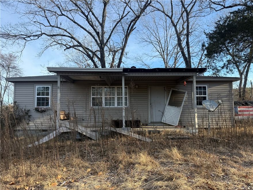 Investment special! Lying on the outskirts of Dover on Hwy 164 E, this home could be brought back to life with the right Buyer! Great view from the back yard! PLEASE CHECK WITH AGENT ABOUT PRIVATE REMARKS!