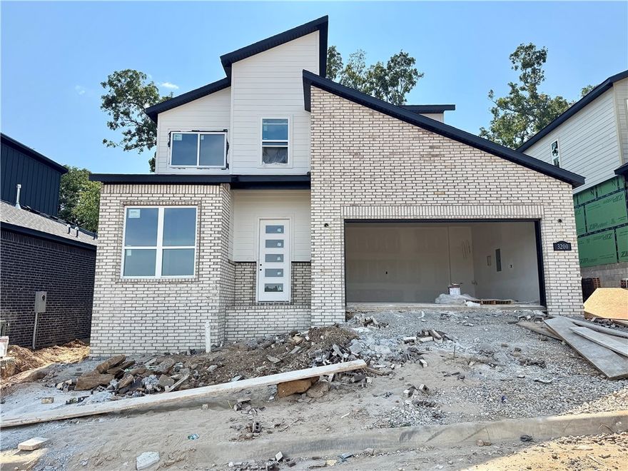 Discover this stunning modern home in the perfect East Fayetteville location—just a short walk to beloved Gulley Park! Quince floorplan featuring designer finishes throughout. Enjoy a spacious open floorplan with a large living room, electric fireplace with accent wall, and beautiful wood flooring. The chef’s kitchen boasts 3cm quartz countertops, stainless steel frigidaire professional-grade appliances, custom cabinets to the ceiling with soft close hinges, vented hood,  and a walk-in pantry. The luxurious primary suite includes hardwood floors, custom beams, and a spa-like bathroom with walk in tile shower, soaking tub, double sinks and walk in closet. With a formal dining area with accent paint, private study with built ins, large covered patio, and included blinds and gutters, this home blends comfort, style, and convenience in one unbeatable package. POA maintained lawncare!