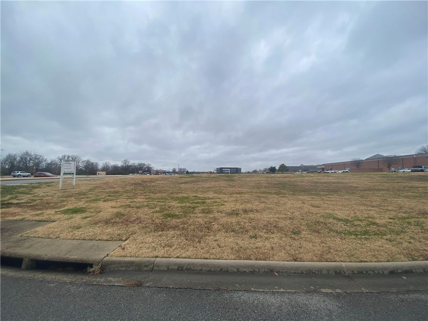 2.63 acre lot available, $12.50 PSF or Build-to-Suit Opportunity. Owner may consider sale or joint-venture. Improved lot with C-2 zoning. Covenant controlled with POA. Less than half a mile from Trail of Two Cities, connecting to Razorback Greenway. Near I-49, Wal-Mart and Sam's Club headquarters and Pinnacle Area of Rogers. Great walkable amenities.