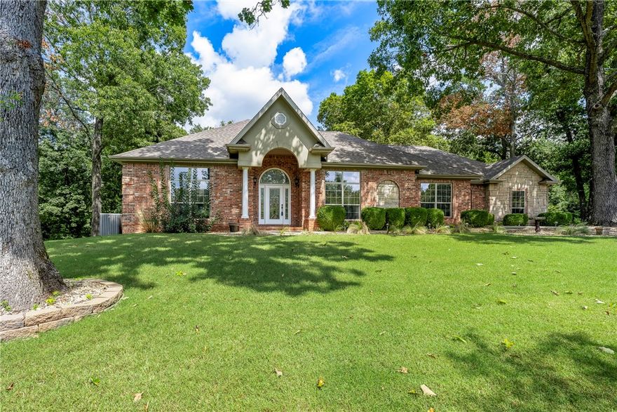 This immaculately maintained all brick home is so private yet conveniently located.  It is just what so many families say they are looking for.  15 minutes to Rogers, Bentonville, and Beaver lake.  The Sugar Creek  golf course is almost in your front yard.  Enjoy wildlife all around.  Other great amenities in this home include the beautiful coiffered ceilings in the living room, custom cabinetry throughout including the builtins and the  27’ deep epoxy floored 3 car garage, the gas HVAC system  recently updated in 2022 and the new roof in 2020 as well as the stainless kitchen appliance package.