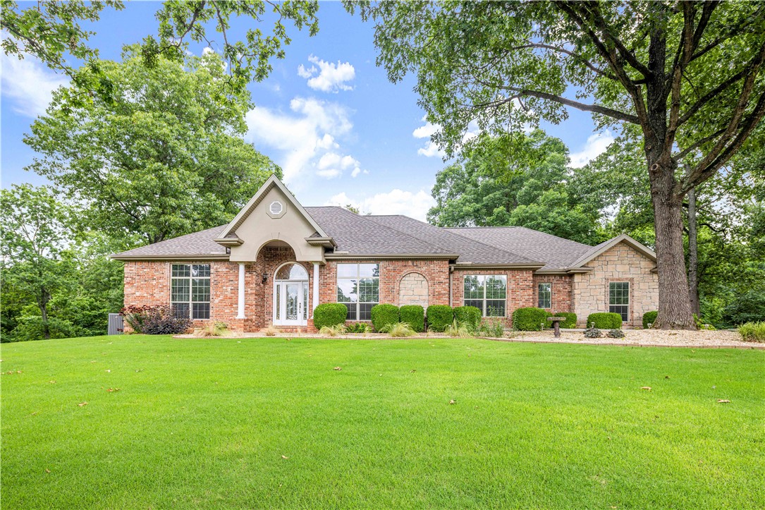 This immaculately maintained all brick home is so private yet conveniently located. It is just what so many families say they are looking for. 15 minutes to Rogers, Bentonville, and Beaver lake. The Sugar Creek golf course is almost in your front yard. Enjoy wildlife all around. Other great amenities in this home include the beautiful coiffered ceilings in the living room, custom cabinetry throughout including the builtins and the 27’ deep epoxy floored 3 car garage, the gas HVAC system recently updated in 2022 and the new roof in 2020 as well as the stainless kitchen appliance package.