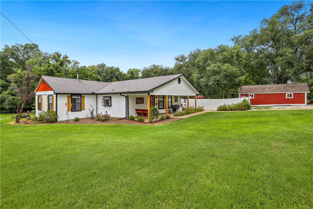 Welcome home! This big beautiful property has it all and is quaintly located in the center of Northwest Arkansas! The lovely home is open and inviting. It has a naturally illuminated floor plan and hosts two large bedrooms and bathrooms, as well a studio/office space. Nestled on a gorgeous large lot in a quiet neighborhood amidst all the action. The land is peaceful, there is plenty of room to enjoy outdoor time with family and the backyard garden is a hobby homestead dream! The property has been very well kept and the upgrades are abundant, new flooring, a/c, furnace, painting and so much more!!