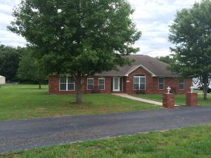 THIS LUXURIOUS 3BR/2BA HOME FEATURES A LARGE GREAT ROOM, CATHEDRAL CEILINGS, WOOD BURNING FULLY DUCTED FIREPLACE, GRANITE COUNTER TOPS, FORMAL DINING, LAUNDRY RM WITH SINK, CUSTOM WOOD BLINDS, LARGE MASTER SUITE, WALK IN TILE SHOWER, HIS & HERS WALK IN CLOSETS, 50 Amp RV HOOK UP, CENTRAL VAC, 10 x 20 STORAGE BLDG, STORM CELLAR, SCREENED IN PATIO, & AN ABOVE GROUND POOL. EXCELLENT LOCATION & VIEW!!