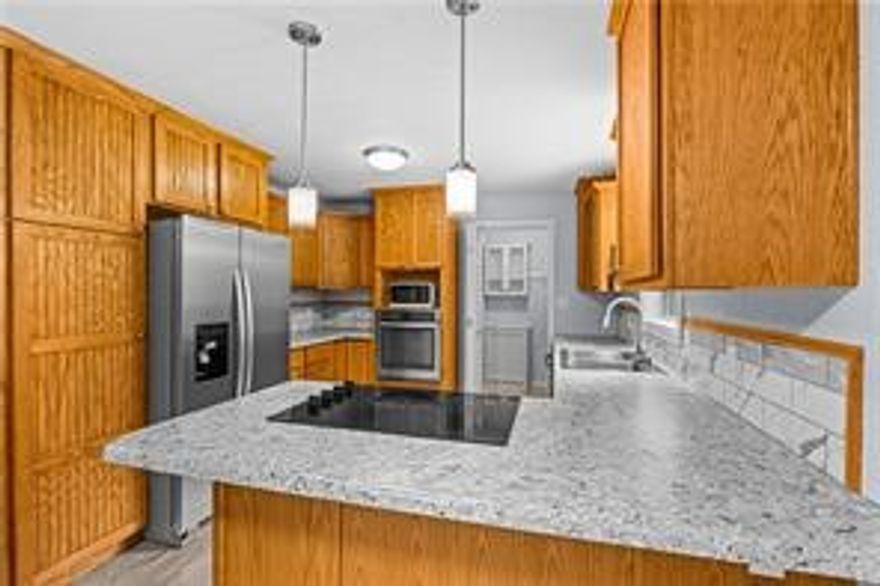 Updated ranch-style home with a large fenced backyard! This 3-bed, 2-bath home was remodeled in 2021 and features stainless steel appliances, custom oak cabinetry, and updated fixtures. Garage conversion created a spacious primary suite with a huge walk-in closet and private bath. Includes a backyard storage building plus a 14x20 heated, cooled, and insulated shop with electric. New A/C and ductwork in 2023. New HVAC in 2023 and water heater replaced within last 5 years. Refrigerator, washer, and dryer convey. Quiet street close to Gentry schools, parks, and shopping. Excellent starter home or investment property. Photos taken prior to furniture being placed.