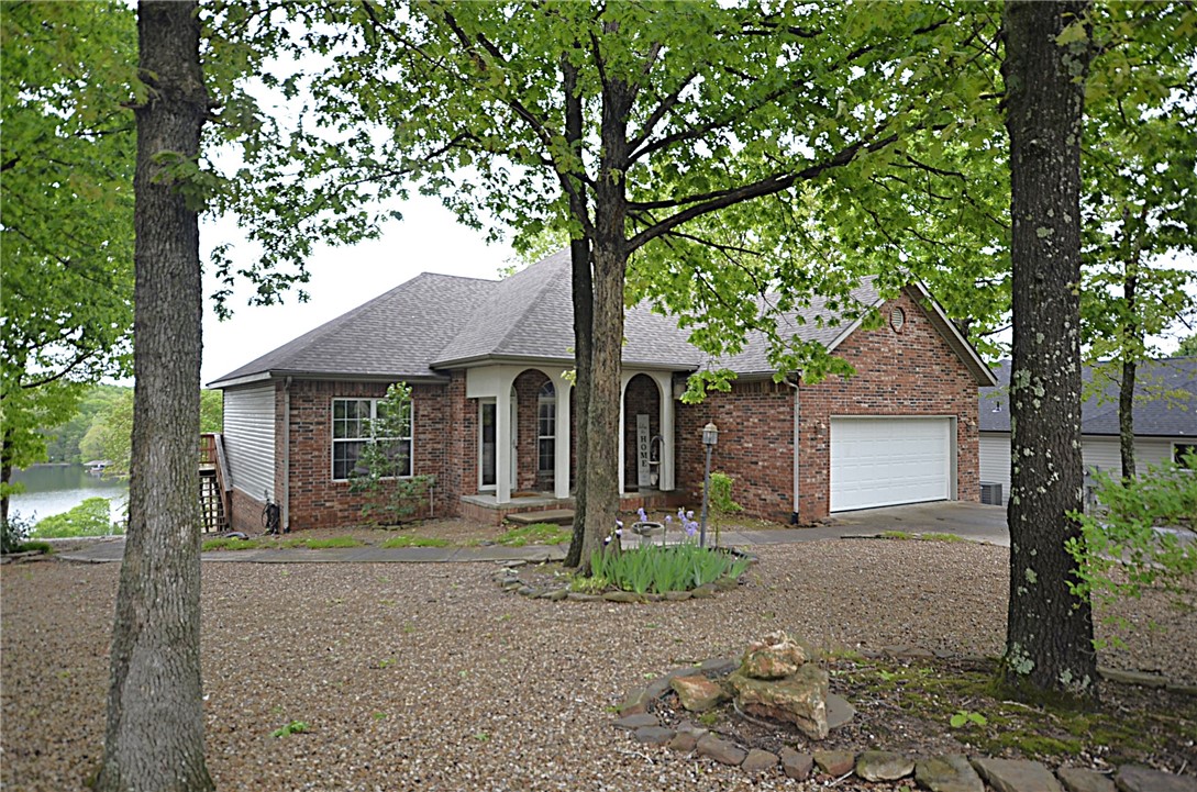 Experience amazing year-round views of Loch Lomond inside and outside this wonderful home. The 2 level home features the Master BR on the main level, an open floor plan, a dining room, a laundry room, and a bonus room currently used as an office. The upper-level deck is perfect for BBQ's with family/friends, while enjoying the adjacent screened porch with its views of the lake. Ample kitchen cabinets and granite counter tops are sure to please. The lower level features 2 BR's plus a second living/game area that is prepared for a kitchenette. A Jack and Jill bath plus another 1/2-bath are also on the lower level. The low maintenance yard is mostly level with some sloping in the back. The fire pit area provides a wonderful view of the lake. A level driveway, quiet neighborhood, 2 miles from Branchwood, Bike Trails, Golf, Lake Access! Just minutes to I-49 (exit 102). Convenience and a view! New septic pump in 2018, new roof in 2019, new upper HVAC unit in 2019, new flooring in 2024, new gas logs in the FP in 2025.