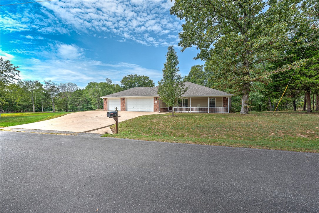 Rare gem! Beautifully maintained one-level split floorplan on level lot w/3-car garage. Boasts covered back deck overlooking tree-lined greenspace. Home features 3 BR's, 2 Full BA's, and 1,785 sf. Garage has epoxy floors, workbench, fixed shelving, and storage racks for all your tools. New roof (2022), new HVAC (2020), and installed wood floors (2020). Welcome Home to the "nature channel".