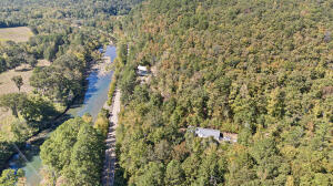 An outdoor enthusiast's dream awaits with this stunning residence on the Mulberry River. Nestled in the heart of the National Forest, the property boasts Briar Branch Creek running through it, with the Mulberry River just 75 yards away. Enjoy limitless access to the river, perfect for kayaking, fishing, or peaceful relaxation, and explore the endless trails and adventure that the National Forest provides. The Ozark Highlands Trail is practically in your backyard, with the High Bank Canoe Entrance just 1 mile away, Byrd Adventure Center 2.5 miles away, and the Indian Creek OHV trail only 0.4 miles from the property. Whether you're seeking outdoor thrills or serene natural beauty, this property offers unparalleled access to it all.