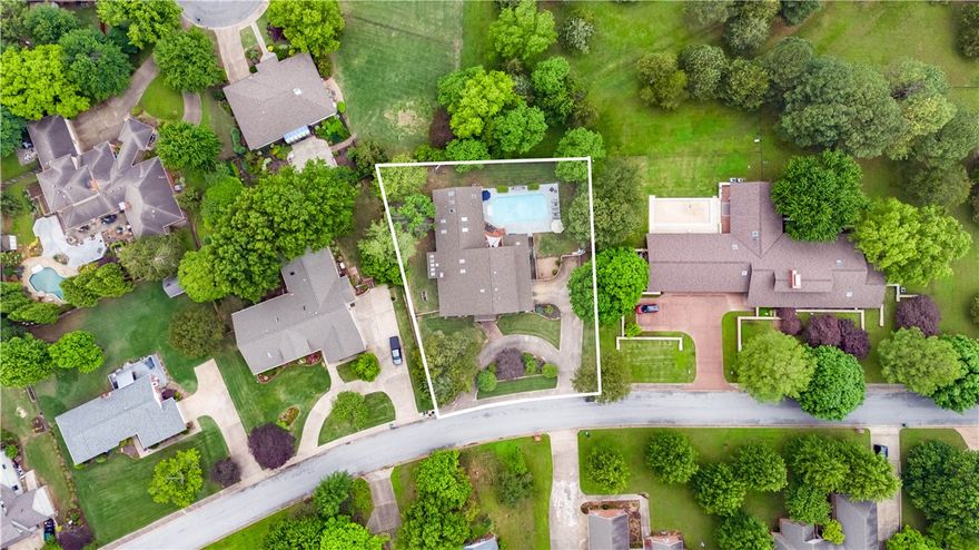 Welcome home to this custom-built contemporary Craftsman gem nestled in the hilltop Fayetteville Country Club Estates. The oversized entry hall welcomes you past the stunning see-through stairs into the open-concept dining/family rooms adorned with cathedral wood-paneled ceilings, rich hardwood floors, gas fireplace & sunroom. Enjoy your private 40x20 ft pool through solid wood sliders accessible from the dining room, primary bedroom, & screened-in porch just off the kitchen & "keeping room.” Main level features 2 primary suites, each w/ walk-in closets & vaulted, wood-paneled ceilings. Larger suite boasts its own walk-in shower, Lasco therapeutic tub, gas fireplace, and cedar closet. New Paint in Primary Bedroom and Bathroom. Upstairs bedrooms branch off from bonus living/loft area landing & each enjoy the privacy of their own half bath, shared shower room, & private balcony. Enjoy poolside entertaining and relaxation on your outdoor composite wood deck, outdoor bar & gas grill.  See the amenities list for more.