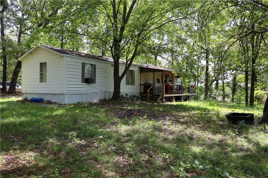 1999 4 bedroom 2 bath trailer house, currently tenant occupied. Does need minor repairs. 2.5+/- acres with incredible view to the South. Beautiful building site. On a very good well. Septic system designed for a 4 bedroom home. 200 amp electric service. As is, no repairs to be done by seller.