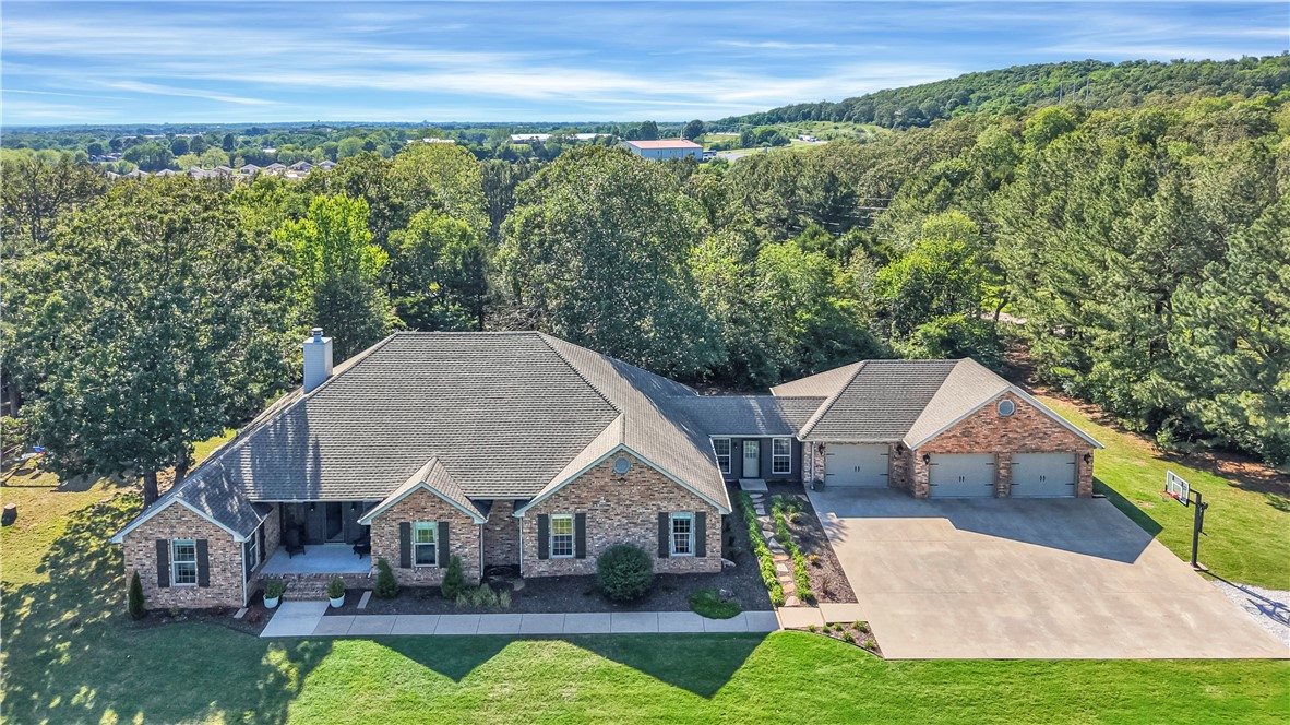 Discover the perfect blend of comfort, space & privacy in this beautifully maintained custom-built home with no neighbors in sight. Designed with both function & luxury in mind, this residence offers room to grow, play, & relax — indoors and out. The home has 3 spacious guest bedrooms, one with its own private en-suite bath, ideal for visitors or multi-generational living. The primary suite is a true retreat, featuring 2 walk-in closets, dual vanities, a jetted soaking tub & direct patio access. The home also boasts a formal dining room, an office space & a versatile secondary living area that can easily serve as a playroom or home gym. The epoxy-finished garage is equipped with a mini split, making it a perfect workshop or hobby space year-round. Step outside to enjoy breathtaking views from both the front and back porches. With total privacy and ample open space, the property offers endless possibilities.This is a rare opportunity to own a home that offers both thoughtful design and stunning natural surroundings.