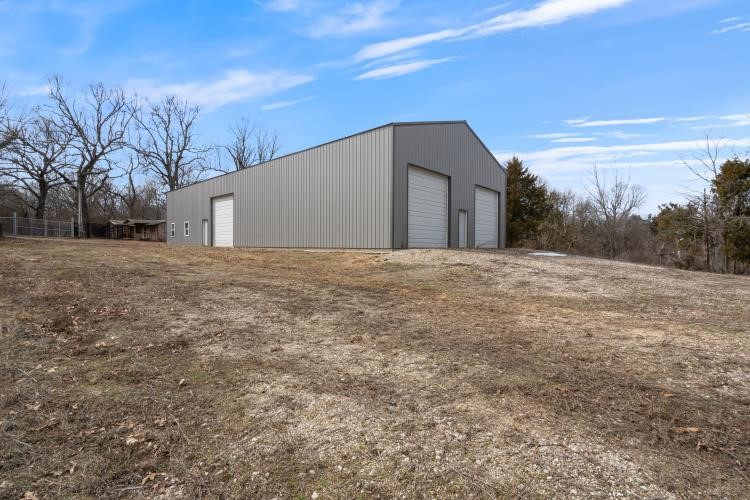 Warehouse with 5.3 acres fenced on 3 sides. Tree lined with ravine on back.
Lock box hanging on walk thru gate.
Call listing agent for code on gate. Agent Owned