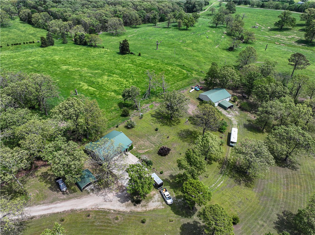 Simply beautiful 5 acres m/l with 3 bed, 1 bath home plus a 40x50 shop with concrete flooring, cedar walls, insulated and has 220 plus it's own septic and CH&A.. The property is a park like setting and home and shop are closer to back of property away from the highway. Home has a roof installed in 2014 and is remodeled throughout. You enter into an open kitchen and living room and then move to the bedrooms towards the back of the house. There are two carports in addition to the shop building. All electric with propane back up. 10x14 building could be a "she" shed as it is insulated and also has 220. there is a great garden spot and lots of blackberry bushes plus apple trees.