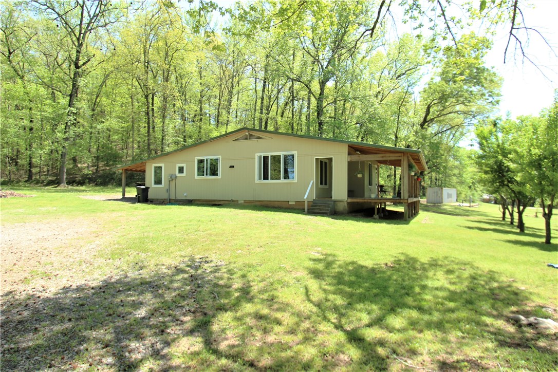 Drink your morning coffee in seclusion on the wrap-around porch of this newly remodeled home. New in 2020: insulation, sheetrock, metal roof, siding, doors, windows, water heater, electric, and plumbing. Original hardwood floors in the living room and 2 of the bedrooms. Home is on a septic system, but city sewer is available. Cash or conventional loans only.