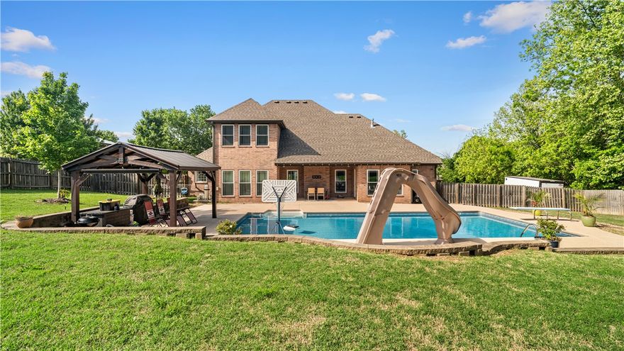 More than a home… this is where life actually happens.
Tucked just minutes from the University of Arkansas, this property was made for the kind of days that turn into your favorite memories—slow mornings, afternoons by the pool, and evenings that somehow last a little longer than planned.
The backyard is the heartbeat of this home. Whether it’s kids racing to the slide, friends gathered under the pergola, or a quiet night with the water lit up around you, it’s the kind of space that naturally brings people together.
Inside, the layout just makes sense. A spacious kitchen built for real life—not just looks—opens into multiple living areas so everyone has their place without feeling disconnected. From weeknight dinners to full-on holiday hosting, this home handles it all with ease.
The primary suite offers a true escape at the end of the day, while upstairs creates the perfect separation for family or guests.
If you’ve been waiting for a home where you can live, host, and unwind all in one place—this is it.