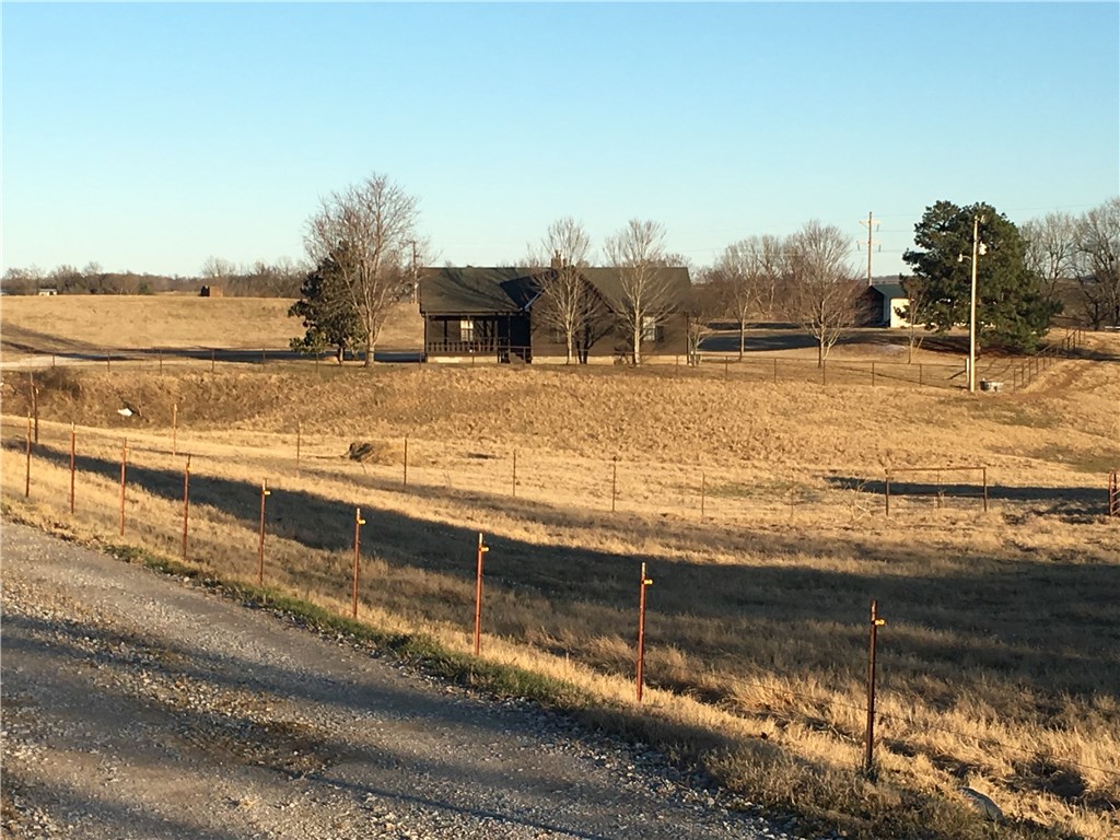 Buy this farm that is just minutes from town and Beaver Lake. Inside you will find beautiful hardwood floors, a vaulted ceiling the the living room with floor to ceiling rock details behind the wood burning stove. Trey ceilings in the dining room and master bedroom. 10 acre lot is fully fenced and ready for cattle or horses.
