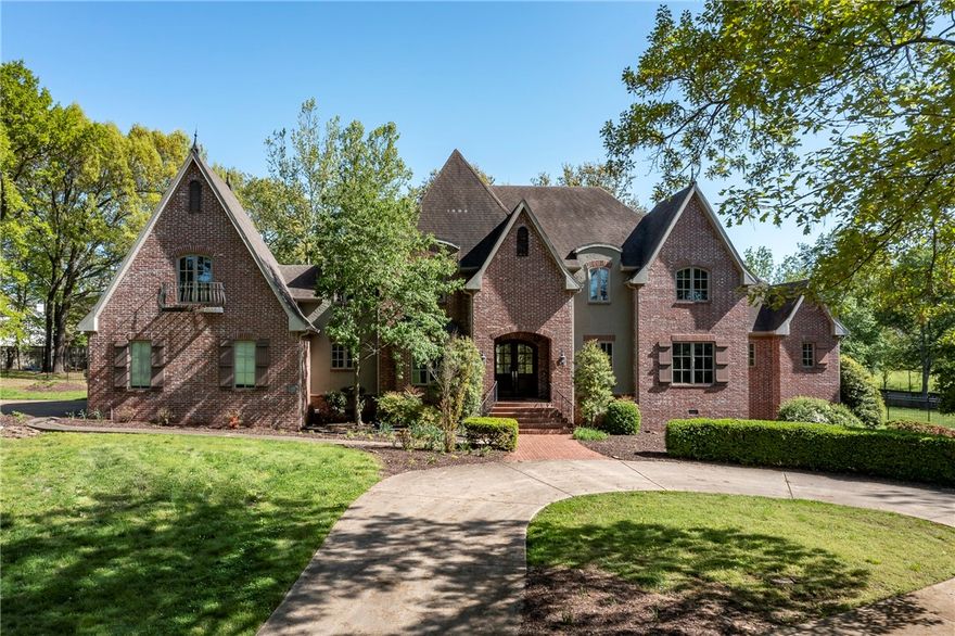 Executive Custom-Built European Estate on 4 acres in the heart of Rogers! Located minutes from the Pinnacle Promenade, this private estate home provides a quiet serene setting yet minutes from everything! House sets back nestled on secluded wooded lot with beautiful mature trees! Gourmet kitchen, hardwood floors, 3 fireplaces, media/bonus room 2 bedrooms on the main level including and a grand Master Suite with his & her private baths and private office.  Tons of storage and lot of custom details throughout.  Expansive back covered porch to enjoy the private backyard setting. Must see to appreciate all this home has to offer and potential of putting your own personal touches on it making it your own private estate!