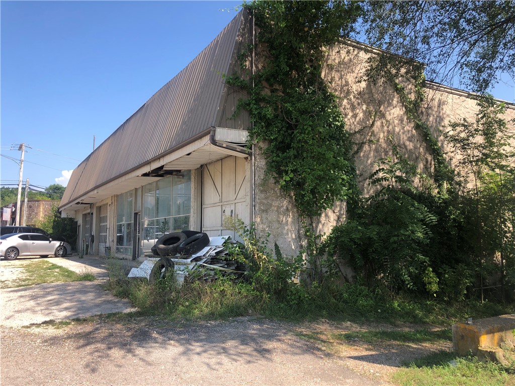 Potential! This was once a Studebaker Showroom, more commonly known as Walker Sales this Huge building is in remarkable shape as far as the structure goes, needs a good scrubbing and a little Tender Loving Care before its showroom ready again. Has amazing location right on 62 and in the back is the beautiful recently refurbished spring with city park and walking trails close.
